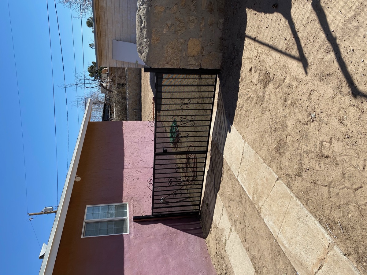 Residential decorative double-swing gate with scrollwork